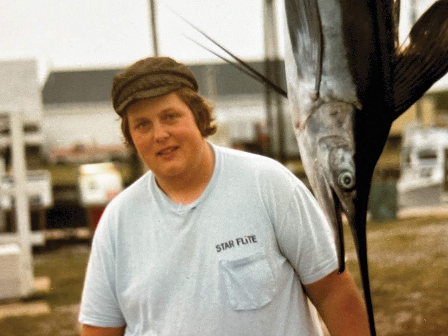 A young Randy Ramsey standing next to a white marlin.